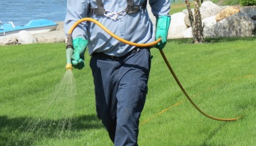 Person carrying spray hose.