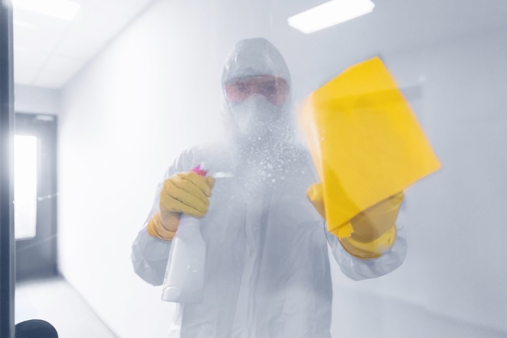 Worker disinfect disinfects surface of bathroom from viruses, germs dust and dirt. Concept house cleaning.